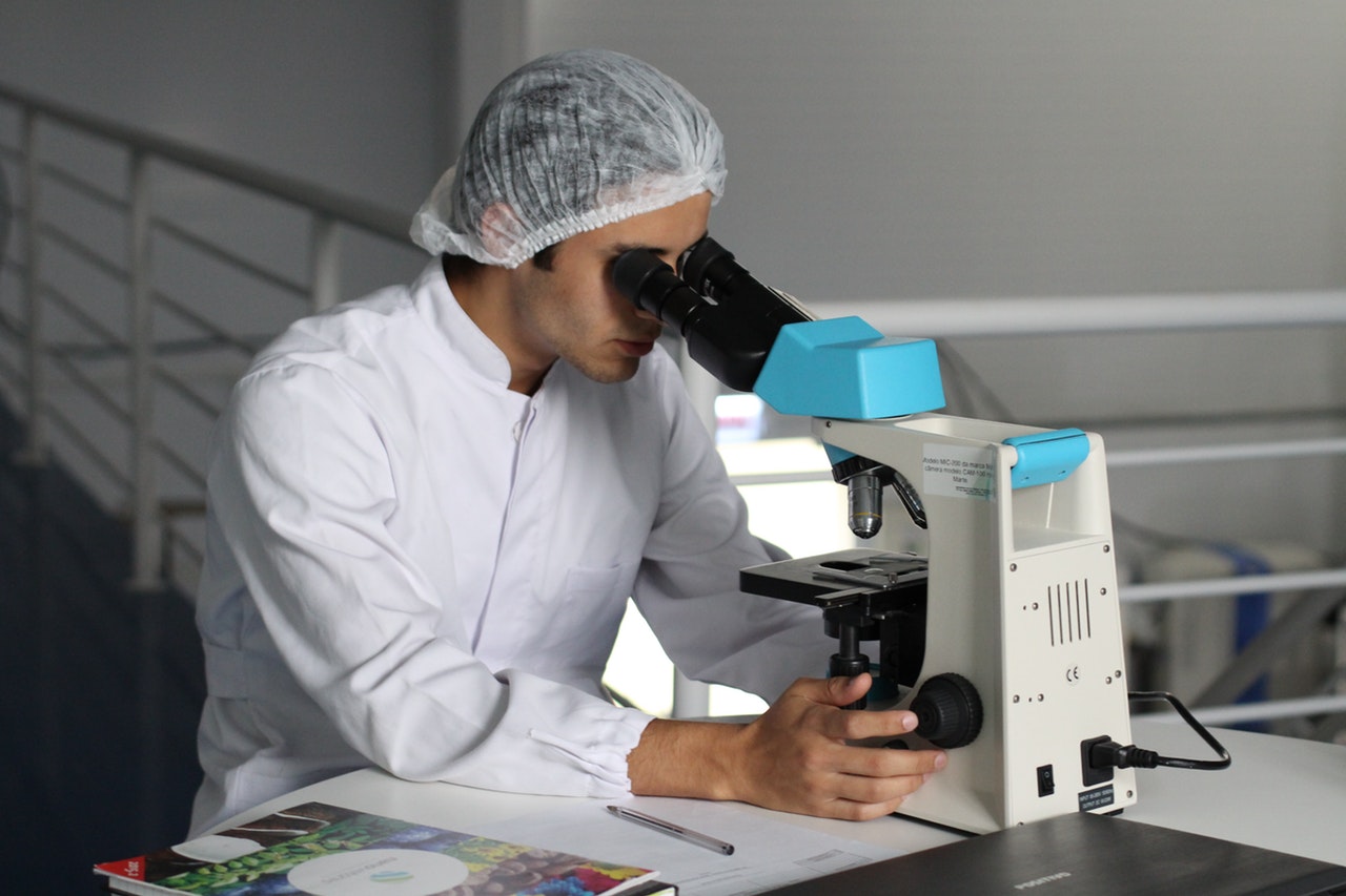 Forsker som ser i mikroskop